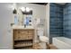 Bathroom with wooden vanity, modern fixtures, and blue tiled walls and shower with laminate flooring at 4750 N Central Ave # 3B, Phoenix, AZ 85012
