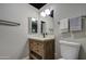 Well-lit bathroom featuring a wooden vanity, sleek fixtures, and modern countertop at 4750 N Central Ave # 3B, Phoenix, AZ 85012