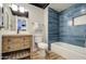 Updated bathroom with stylish blue tile, modern vanity, and clean fixtures with updated vinyl flooring at 4750 N Central Ave # 3B, Phoenix, AZ 85012