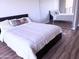 Bright bedroom featuring a modern bed, wood floors, and mirrored closet for an open, airy feel at 4750 N Central Ave # 3B, Phoenix, AZ 85012