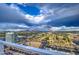 Stunning cityscape view from a high-rise, showcasing urban architecture against a backdrop of mountains and cloudy skies at 4750 N Central Ave # 3B, Phoenix, AZ 85012