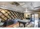 Entertainment-ready game room featuring a pool table and extensive built-in shelving for books and media at 4750 N Central Ave # 3B, Phoenix, AZ 85012