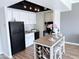 Bright kitchen featuring stainless steel appliances, white cabinetry, and a stylish kitchen island at 4750 N Central Ave # 3B, Phoenix, AZ 85012