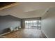 Sun-filled living area with a large sliding glass door to the patio, chair set, and wood-look floors at 4750 N Central Ave # 3B, Phoenix, AZ 85012