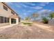 Expansive backyard with a covered patio, desert landscaping, and block wall fencing at 4831 N 93Rd Dr, Phoenix, AZ 85037