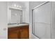 Bathroom featuring a shower with patterned glass, a vanity, and a large mirror at 4831 N 93Rd Dr, Phoenix, AZ 85037