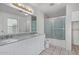Bright bathroom with a double vanity, granite countertop, decorative mirror and glass enclosed shower at 4831 N 93Rd Dr, Phoenix, AZ 85037