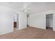 Bright bedroom with neutral walls, carpet, and a walk-in closet next to an ensuite bath at 4831 N 93Rd Dr, Phoenix, AZ 85037