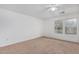 Neutral bedroom with carpeted floor, windows, and a ceiling fan for comfortable living at 4831 N 93Rd Dr, Phoenix, AZ 85037