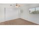 Bedroom features a large sliding closet, window, and neutral carpet at 4831 N 93Rd Dr, Phoenix, AZ 85037