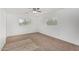 Cozy bedroom features fresh paint, neutral carpet, and a ceiling fan at 4831 N 93Rd Dr, Phoenix, AZ 85037