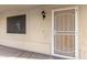 Covered entryway featuring a security door and wall-mounted lantern next to trash receptacle at 4831 N 93Rd Dr, Phoenix, AZ 85037