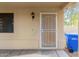 Covered entryway featuring a security door and wall-mounted lantern next to trash receptacle at 4831 N 93Rd Dr, Phoenix, AZ 85037