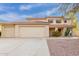 Charming two-story home with a red tile roof, three-car garage, and desert landscaping at 4831 N 93Rd Dr, Phoenix, AZ 85037