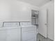 Practical laundry area with washer, dryer, and a door leading to the garage at 4831 N 93Rd Dr, Phoenix, AZ 85037