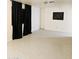 Minimalist room with neutral walls, tile flooring, and dark curtains for modern comfort at 4831 N 93Rd Dr, Phoenix, AZ 85037