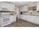 Modern kitchen with white cabinets, hardwood floors, stainless steel appliances, and a view to the sink at 5006 E Forge Ave, Mesa, AZ 85206