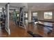 Community gym with weights and machines, mirrored wall, and wood-look flooring at 5350 E Deer Valley Dr # 1419, Phoenix, AZ 85054