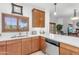 Charming kitchen with quartz countertops, wood cabinets, stainless dishwasher, and natural light at 5350 E Deer Valley Dr # 1419, Phoenix, AZ 85054