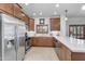 Kitchen with stainless steel appliances, wood cabinets, white countertops, and tile flooring at 5350 E Deer Valley Dr # 1419, Phoenix, AZ 85054