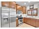 Well-equipped kitchen showcasing stainless steel appliances, modern fixtures, and wood cabinetry at 5350 E Deer Valley Dr # 1419, Phoenix, AZ 85054