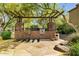 Outdoor kitchen with brick base, stone columns, granite countertops, and stainless steel appliances at 5350 E Deer Valley Dr # 1419, Phoenix, AZ 85054