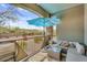 Outdoor patio with seating and a view of the street, plus a blue umbrella for shade at 5350 E Deer Valley Dr # 1419, Phoenix, AZ 85054
