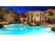 Resort-style pool with lush landscaping, fire bowls, and comfortable lounge chairs under palm trees at 5350 E Deer Valley Dr # 1419, Phoenix, AZ 85054