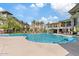 Large pool area with comfortable lounge seating, umbrellas, and a building with bar and restaurant at 5350 E Deer Valley Dr # 1419, Phoenix, AZ 85054