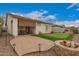 Spacious backyard with a putting green, a paver patio, a built-in firepit, and scenic views at 606 S 124Th Ave, Avondale, AZ 85323