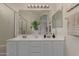 Bright bathroom with double sinks, large mirror, and walk-in shower at 606 S 124Th Ave, Avondale, AZ 85323