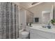 Bright bathroom with shower-tub, vanity with sink, large mirror, and neutral finishes at 606 S 124Th Ave, Avondale, AZ 85323