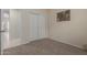Carpeted bedroom featuring an entryway and a closet with bi-fold doors at 606 S 124Th Ave, Avondale, AZ 85323