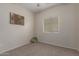 Neutral bedroom featuring carpet floors and a large window with blinds at 606 S 124Th Ave, Avondale, AZ 85323