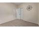 Carpeted bedroom featuring closet doors, and an entryway with tile beyond at 606 S 124Th Ave, Avondale, AZ 85323