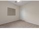 Neutral bedroom featuring carpet floors, a window with blinds, and a ceiling fan at 606 S 124Th Ave, Avondale, AZ 85323