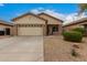 Charming single-level home with a two-car garage and desert landscaping at 606 S 124Th Ave, Avondale, AZ 85323