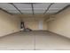 Spacious garage featuring epoxy floors, storage shelves, and a water heater at 606 S 124Th Ave, Avondale, AZ 85323
