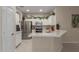 Well-lit kitchen boasts white cabinets, stainless steel appliances, and a spacious island at 606 S 124Th Ave, Avondale, AZ 85323