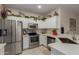 Bright kitchen featuring stainless steel appliances, white cabinetry, and stylish countertops at 606 S 124Th Ave, Avondale, AZ 85323