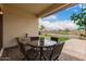 Outdoor patio featuring a round table, chairs, and an artificial turf putting green at 606 S 124Th Ave, Avondale, AZ 85323