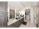 Elegant bathroom featuring double sinks, modern fixtures, and a walk-in closet at 6166 N Scottsdale Rd # C4004, Paradise Valley, AZ 85253