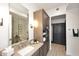 Bright bathroom with a large mirror and updated cabinets and fixtures at 6166 N Scottsdale Rd # C4004, Paradise Valley, AZ 85253