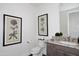 Bathroom featuring a white toilet, gray vanity with granite counters, and framed botanical art at 6166 N Scottsdale Rd # C4004, Paradise Valley, AZ 85253