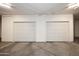 A well-lit garage offering parking for two vehicles with two closed white garage doors at 6166 N Scottsdale Rd # C4004, Paradise Valley, AZ 85253