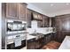 Modern kitchen with stainless steel appliances and dark wood cabinets at 6166 N Scottsdale Rd # C4004, Paradise Valley, AZ 85253