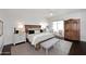 Spacious main bedroom with wood floors, sitting area, and stylish decor at 6166 N Scottsdale Rd # C4004, Paradise Valley, AZ 85253