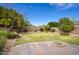 Spacious backyard featuring a well-maintained lawn, stone accents, and a firepit at 6608 W Whispering Wind Dr, Glendale, AZ 85310