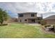 Beautiful backyard featuring a patio, lush green grass, stone accents, and privacy walls at 6608 W Whispering Wind Dr, Glendale, AZ 85310