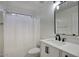 Bright bathroom featuring a white vanity, framed mirror, and shower with tub at 6608 W Whispering Wind Dr, Glendale, AZ 85310